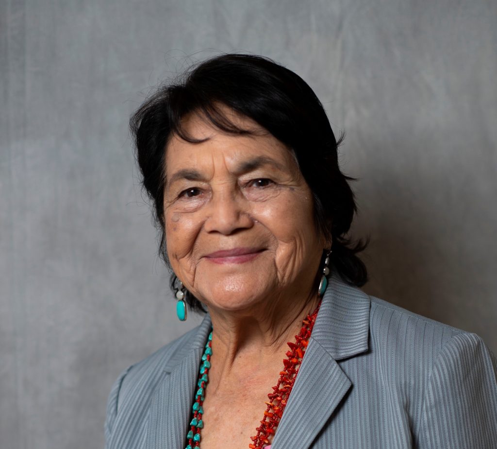 Image shows a formal photo portrait of American Labor Leader Dolores Huerta when attending the United State of Women Summit on May 5, 2018, in Los Angeles, California. The picture accompanies Huerta's quote about everyone being an organizer during the COVID-19 crisis.